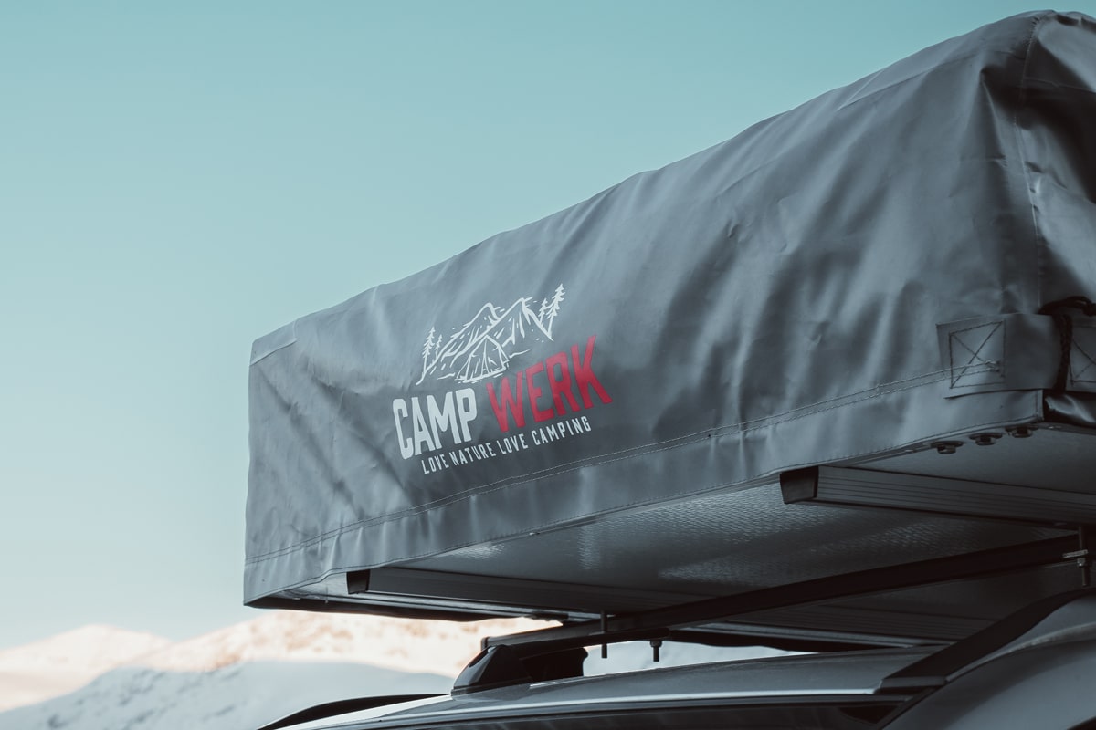 Fantastico: una tenda da tetto davanti a montagne innevate in inverno. Ma chi non va in campeggio, dovrebbe conservarla correttamente